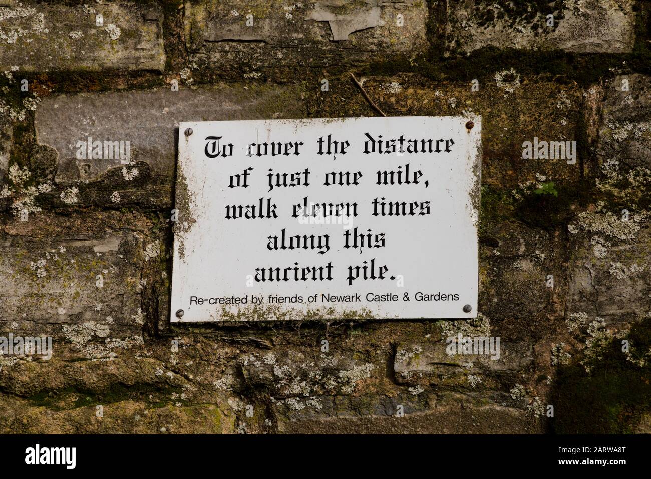 Sign in Newark Castle ruins, “to cover the distance of just one mile, walk eleven times along this ancient pile”, Newark upon Trent, Nottinghamshire, Stock Photo