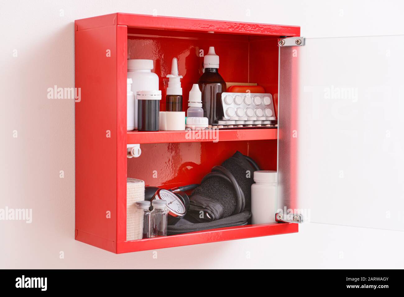 Wall mounted first aid kit on light background Stock Photo - Alamy