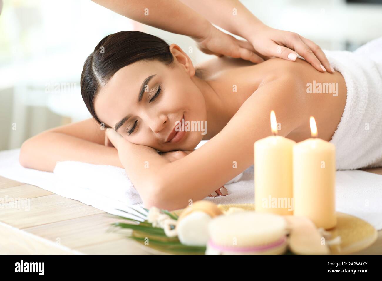Beautiful young woman relaxing in spa salon Stock Photo - Alamy