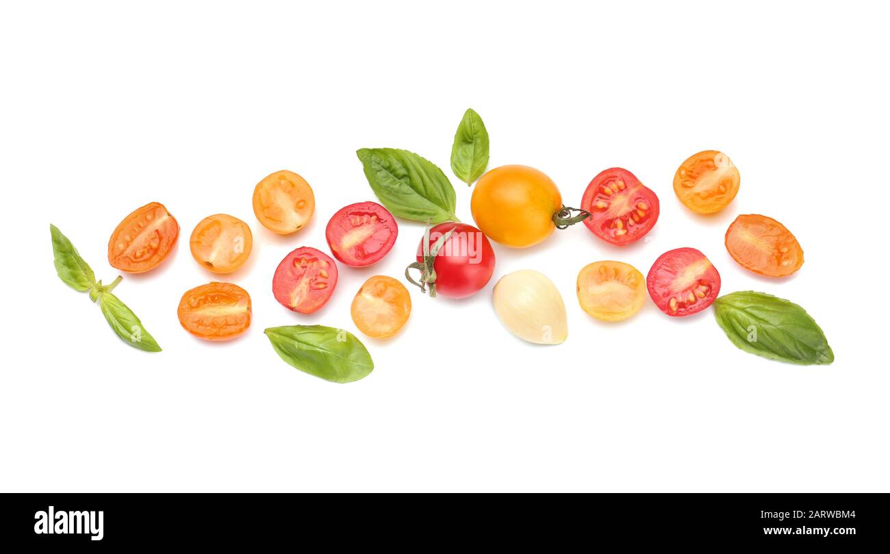 Different fresh tomatoes with basil on white background Stock Photo - Alamy