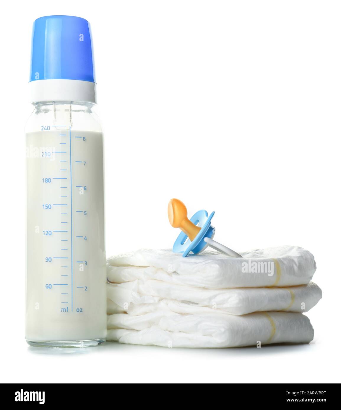 Bottle of milk for baby with pacifier and diapers on white background ...