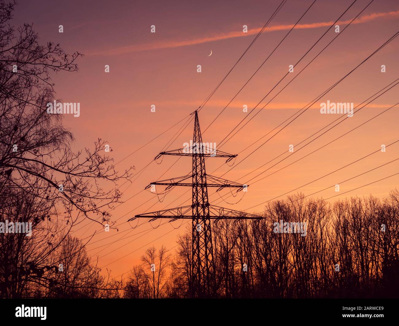 Silhouette of poles and power lines in the sunset Stock Photo - Alamy