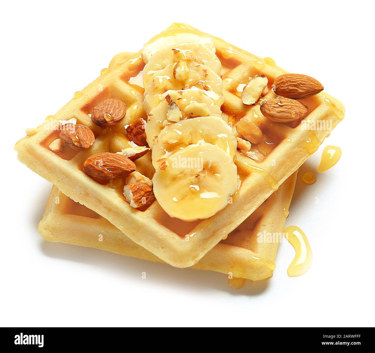 Tasty waffles with bananas, honey and almonds on white background Stock ...