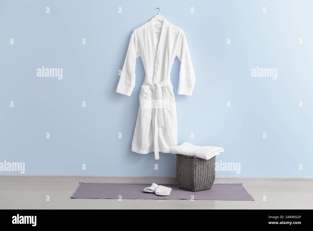 Clean bathrobe hanging on wall in room Stock Photo Alamy