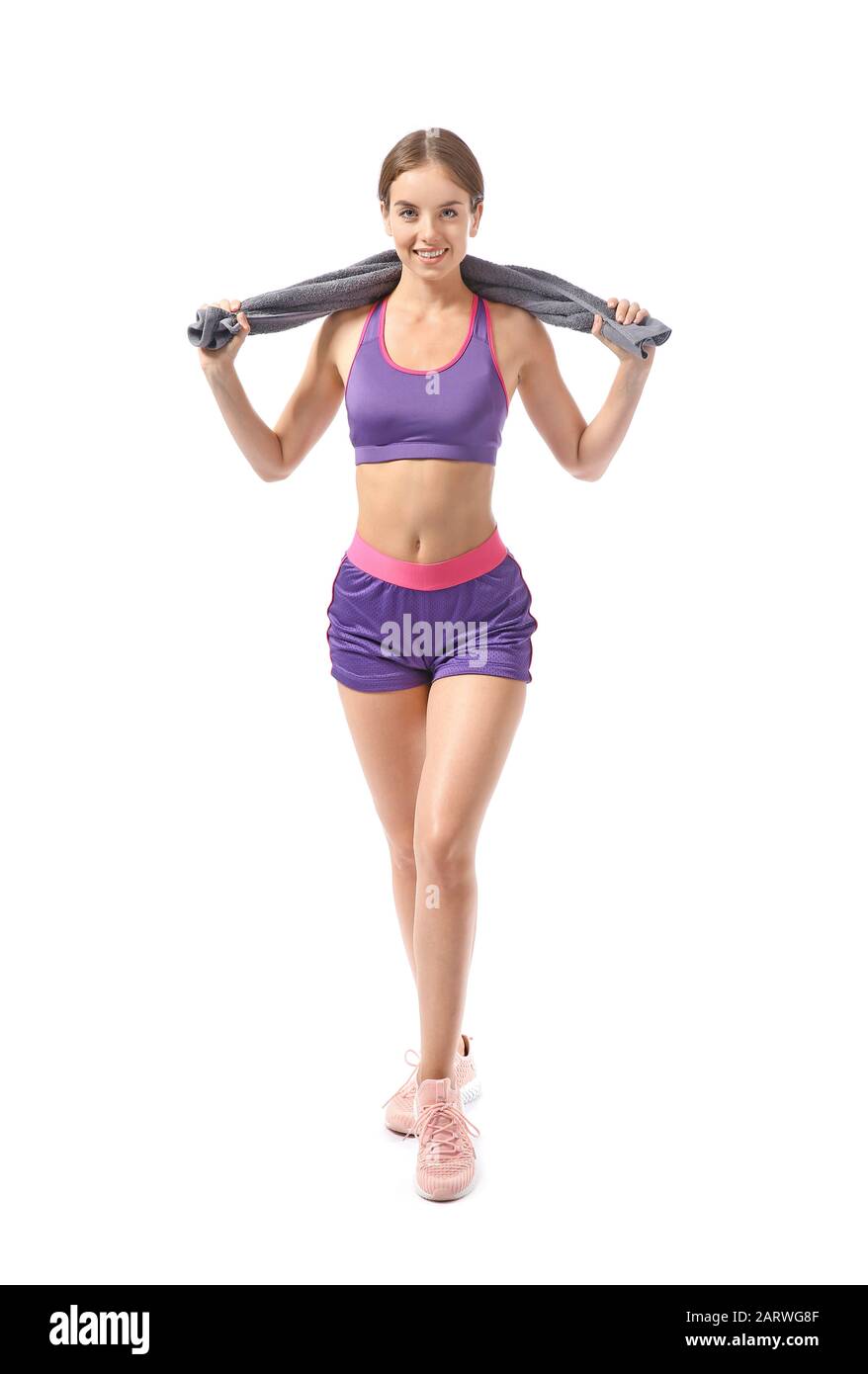 Sporty young woman with towel against white background Stock Photo - Alamy