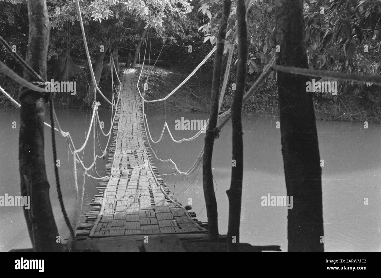 Shock troops at Praboemoelih  Talang Djimar (at Praboemoelih): The Wilhelmina Bridge, a suspension bridge, by the infantrymen of the 3rd section, 2nd platoon of 1-7 R.S. from bamboo constructed. On 31 August 1947, this bridge was opened over the Ajer Rambangi near Prabamoelih. Date: 23 October 1947 Location: Indonesia, Dutch East Indies, Sumatra Stock Photo