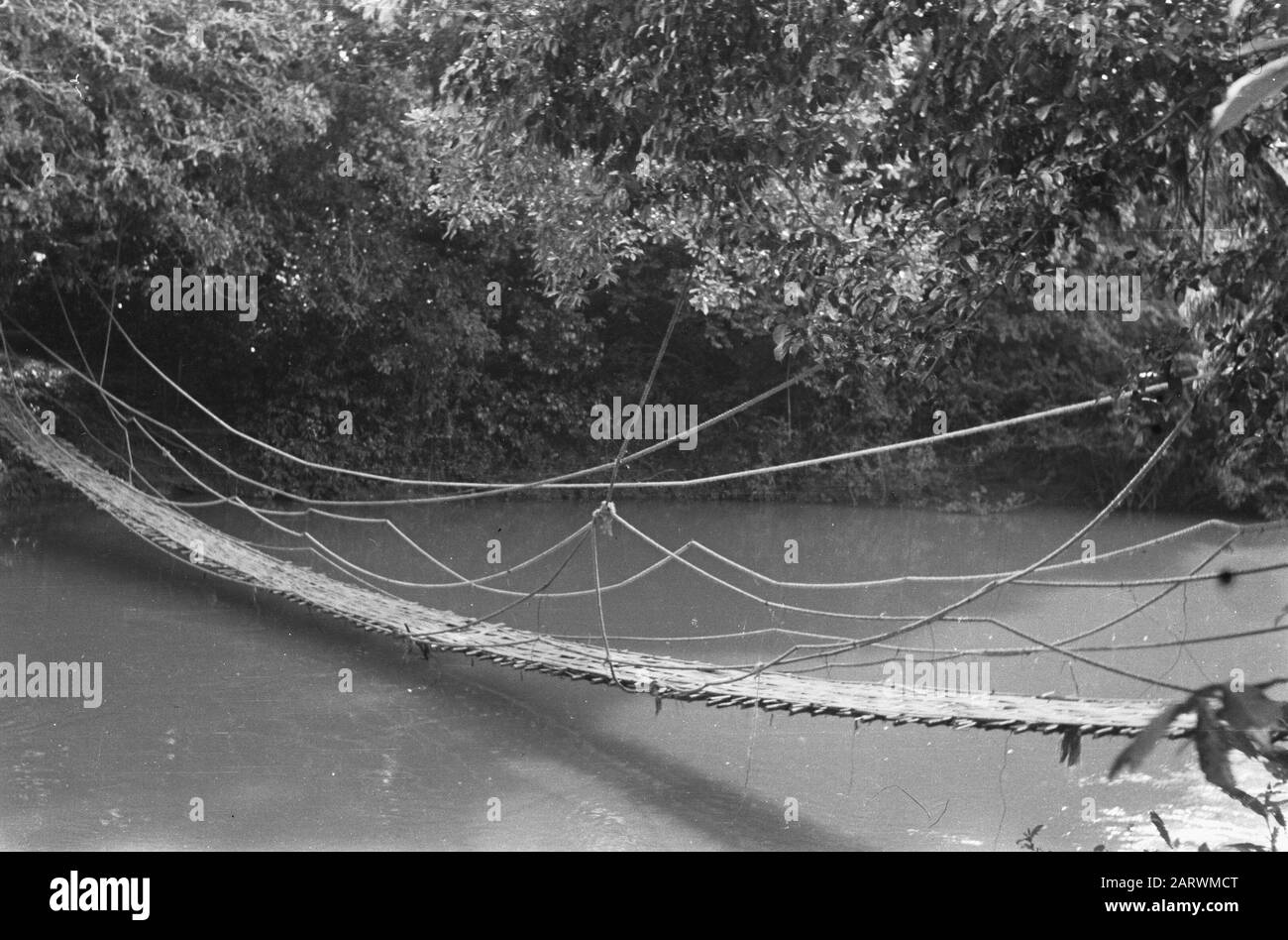 Shock troops at Praboemoelih  Talang Djimar (at Praboemoelih): The Wilhelmina Bridge, a suspension bridge, by the infantrymen of the 3rd section, 2nd platoon of 1-7 R.S. from bamboo constructed. On 31 August 1947, this bridge was opened over the Ajer Rambangi near Prabamoelih. Date: October 23, 1947 Location: Indonesia, Dutch East Indies Stock Photo