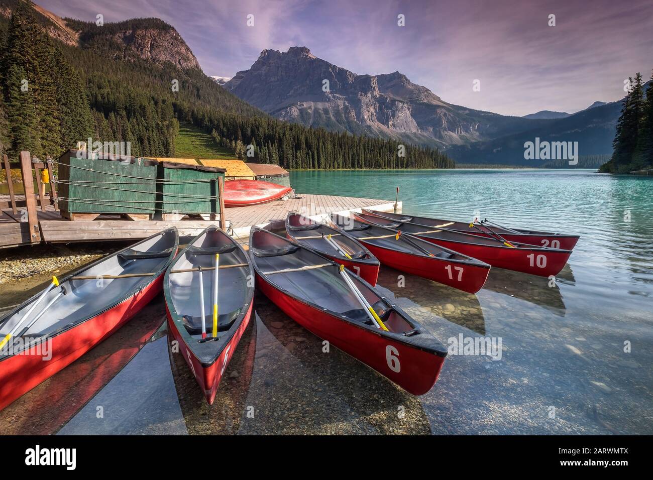 Canoes on Emerald Lake backed by The President Range, Yoho National Park, The Rockies, Alberta, Canada Stock Photo