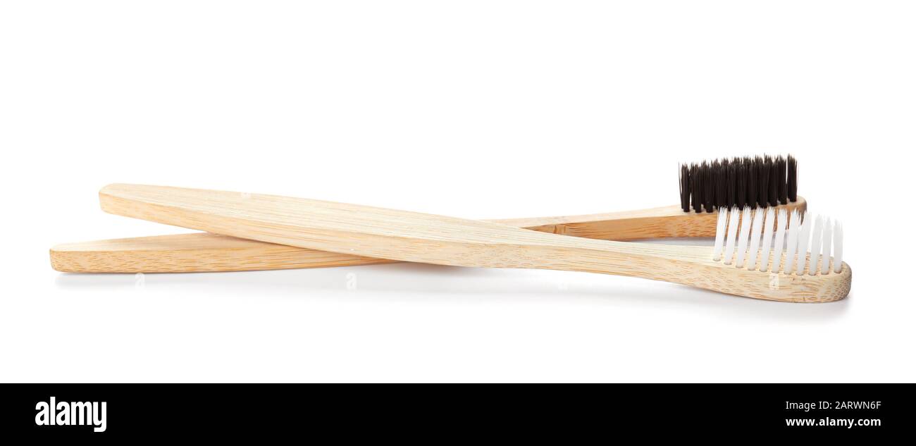 Wooden tooth brushes on white background Stock Photo - Alamy
