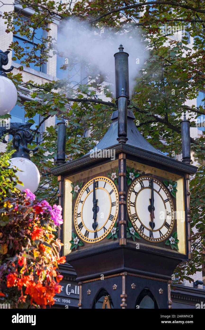 The Gastown Steam Clock strikes 6pm, Gastown, Vancouver, British Columbia, Canada Stock Photo