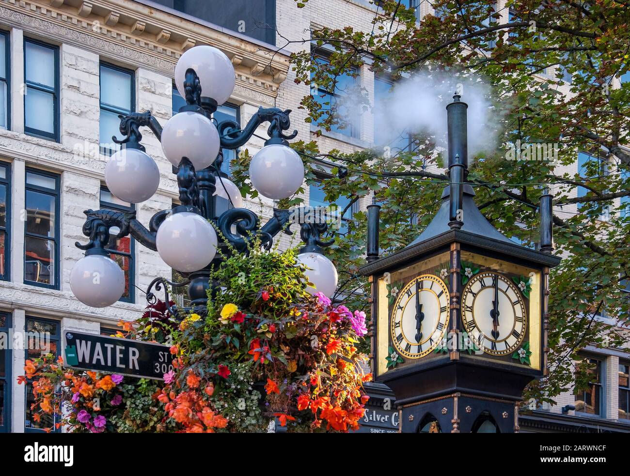 The Gastown Steam Clock strikes 6pm, Gastown, Vancouver, British Columbia, Canada Stock Photo