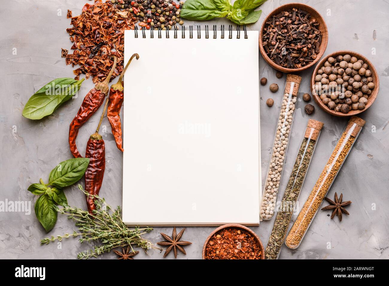 Empty notebook with different spices on grunge background Stock Photo