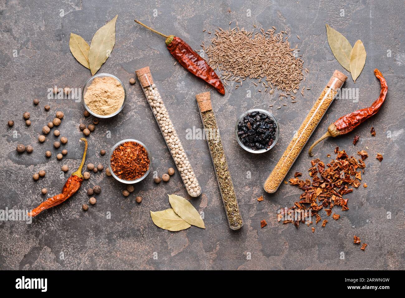 Different spices on grey background Stock Photo