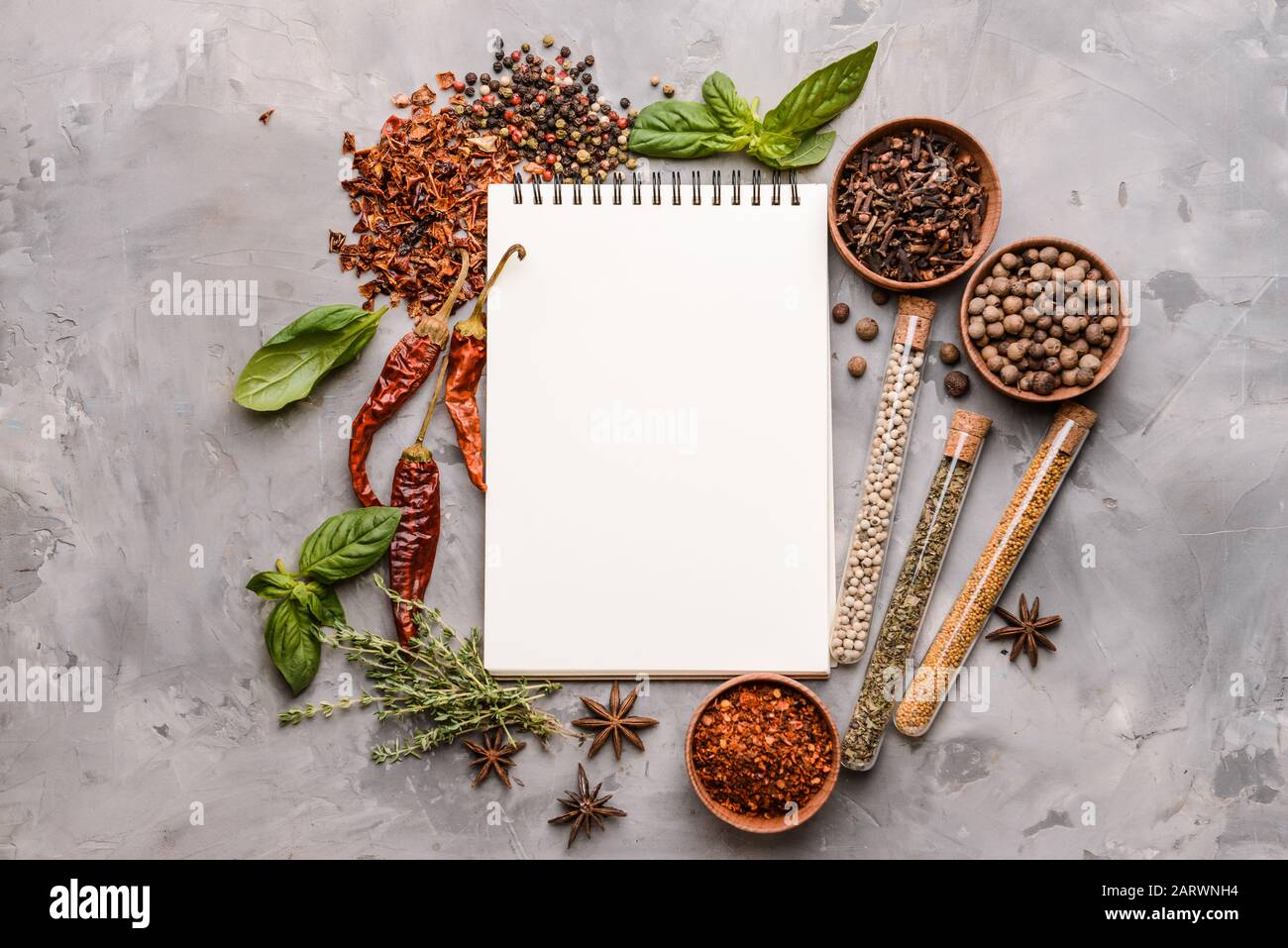 Empty notebook with different spices on grunge background Stock Photo