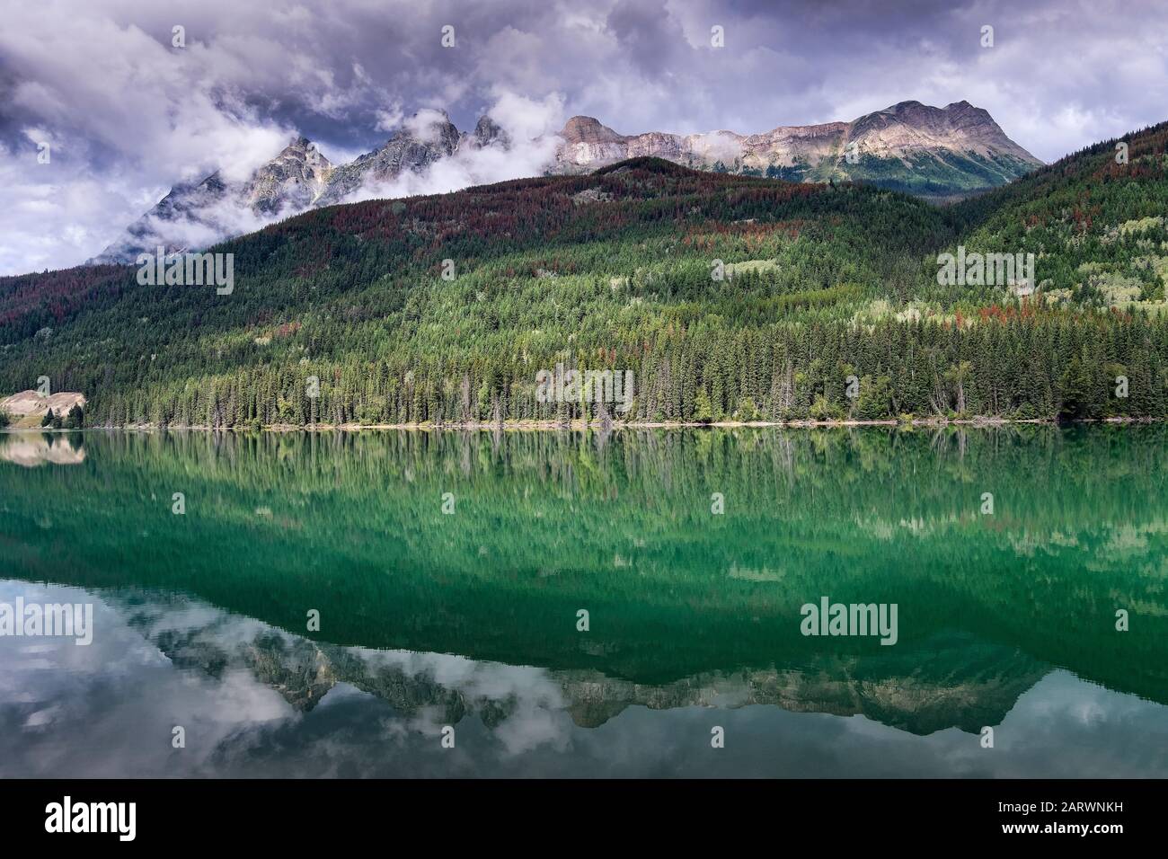 Mount Fitzwilliam reflected in Yellowhead Lake at the turn of Fall, Mount Robson Provincial Park, Canadian Rockies, British Columbia, Canada Stock Photo