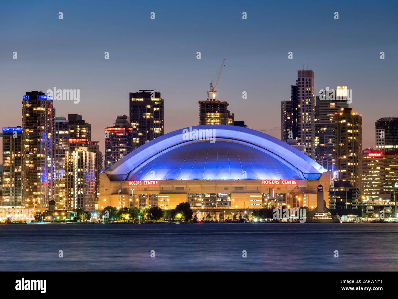 The Rogers Center or SkyDome across Lake Ontario at night, Toronto, Ontario, Canada Stock Photo