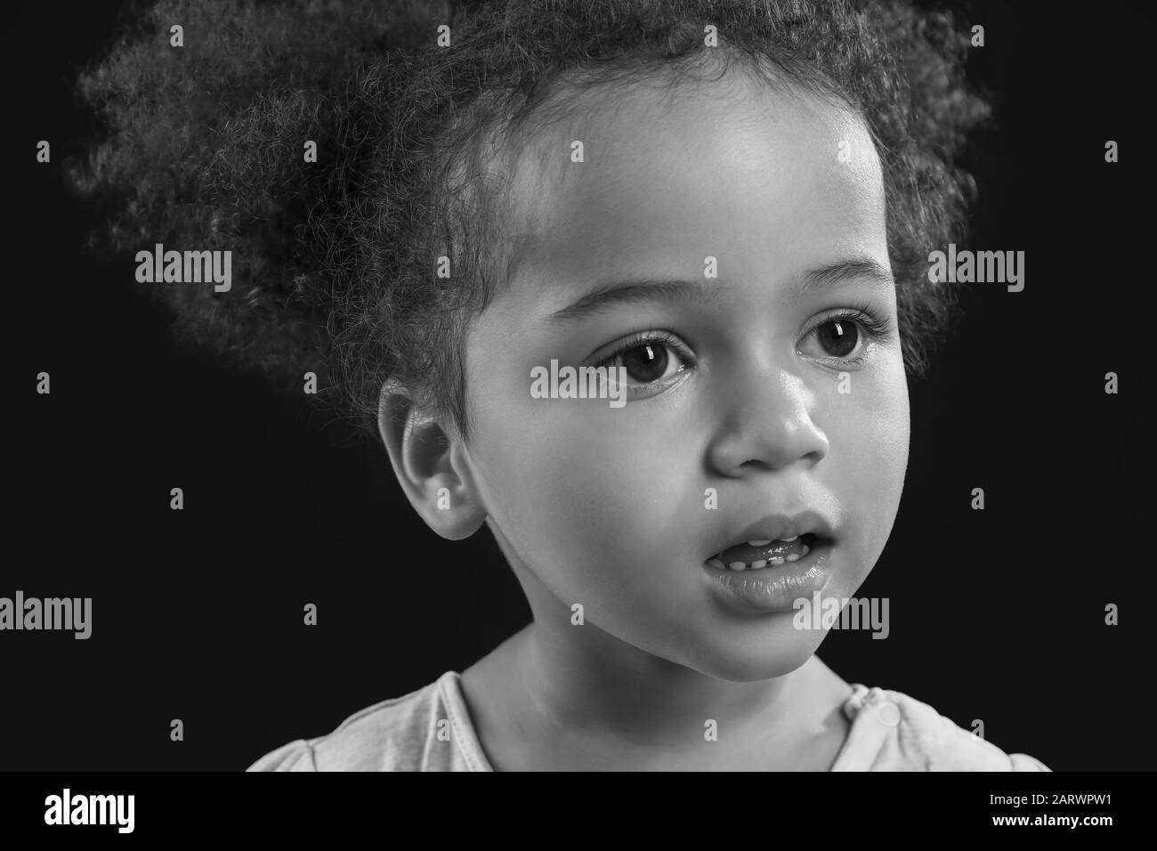 Black and white portrait of little African-American girl on dark ...