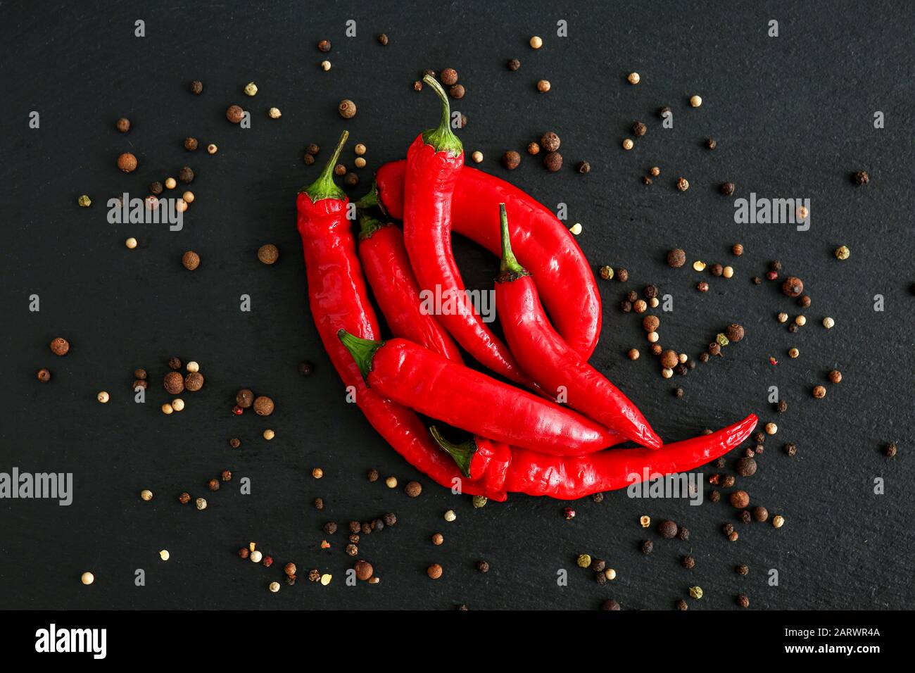 Hot chili peppers and peppercorn on dark background Stock Photo Alamy