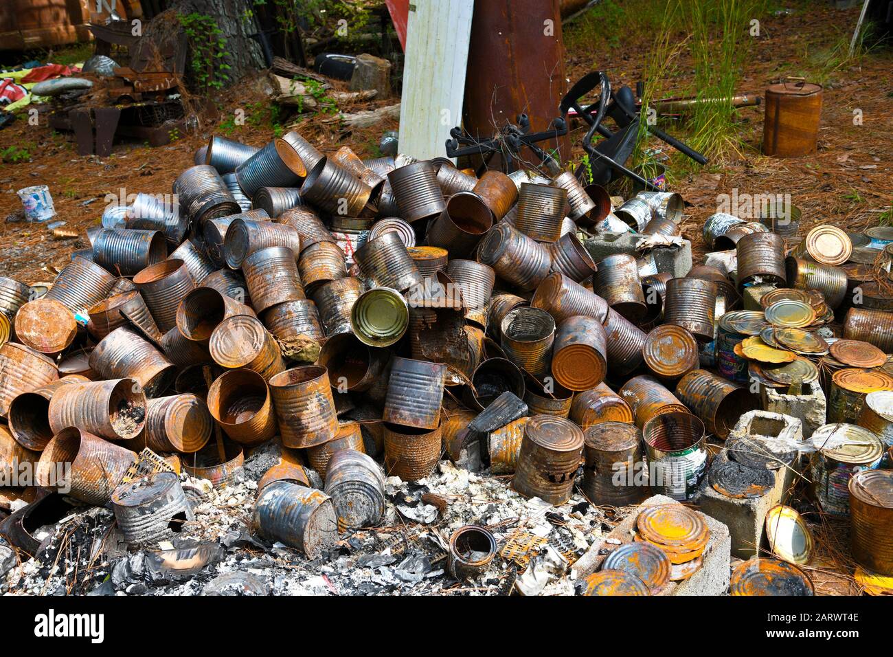 A pile of metal cans and other items at an Illegal Dump Site Stock Photo