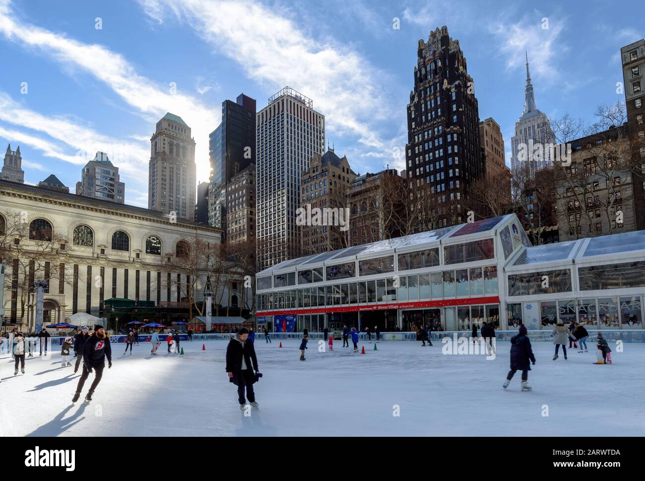 NEW YORK (Manhattan), USA: January 20, 2018: Bryant Park winter rink in the morning with midtown buildings in the background. Stock Photo
