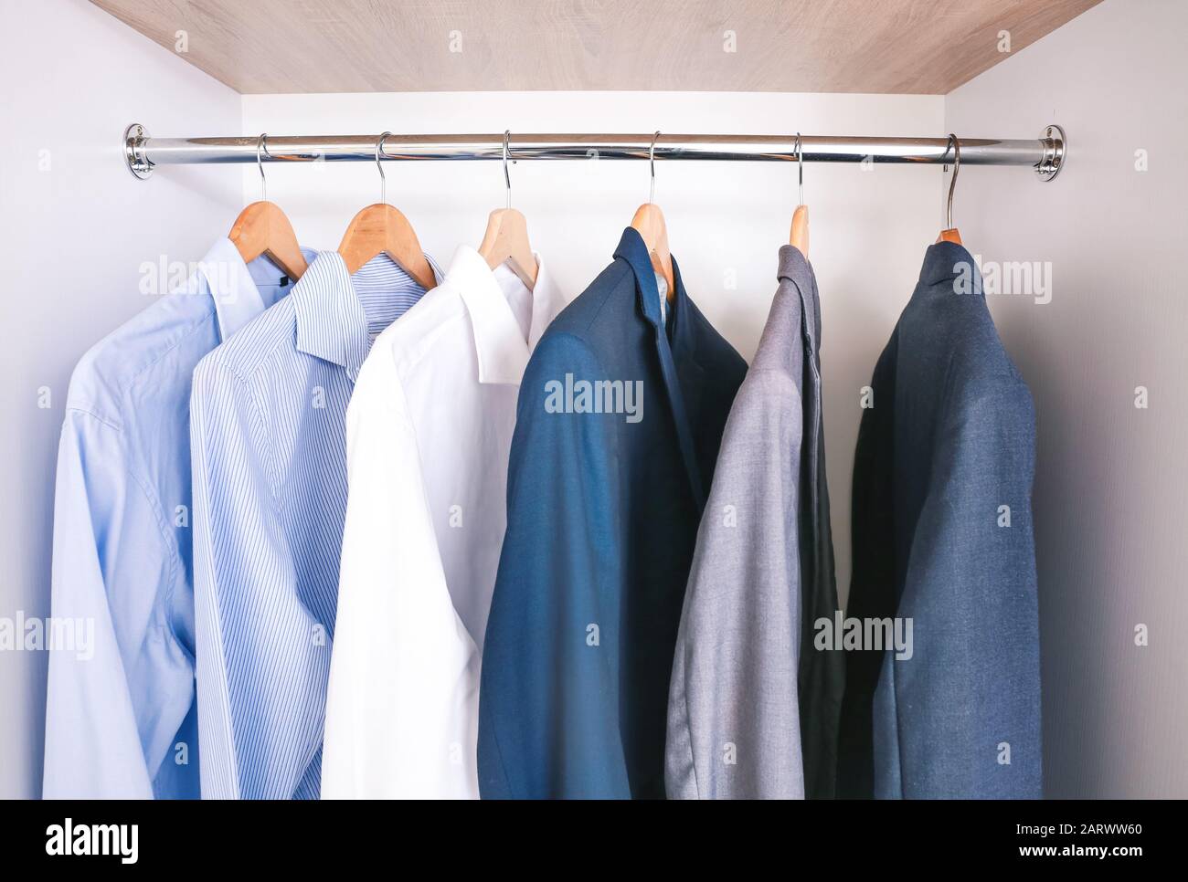 Clothes hanging on rack in wardrobe Stock Photo Alamy