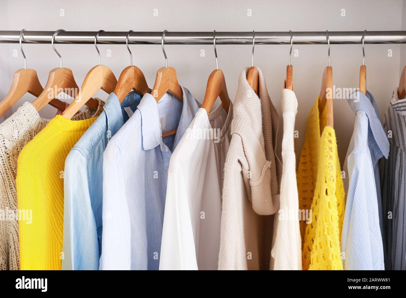 Clothes hanging on rack in wardrobe Stock Photo Alamy
