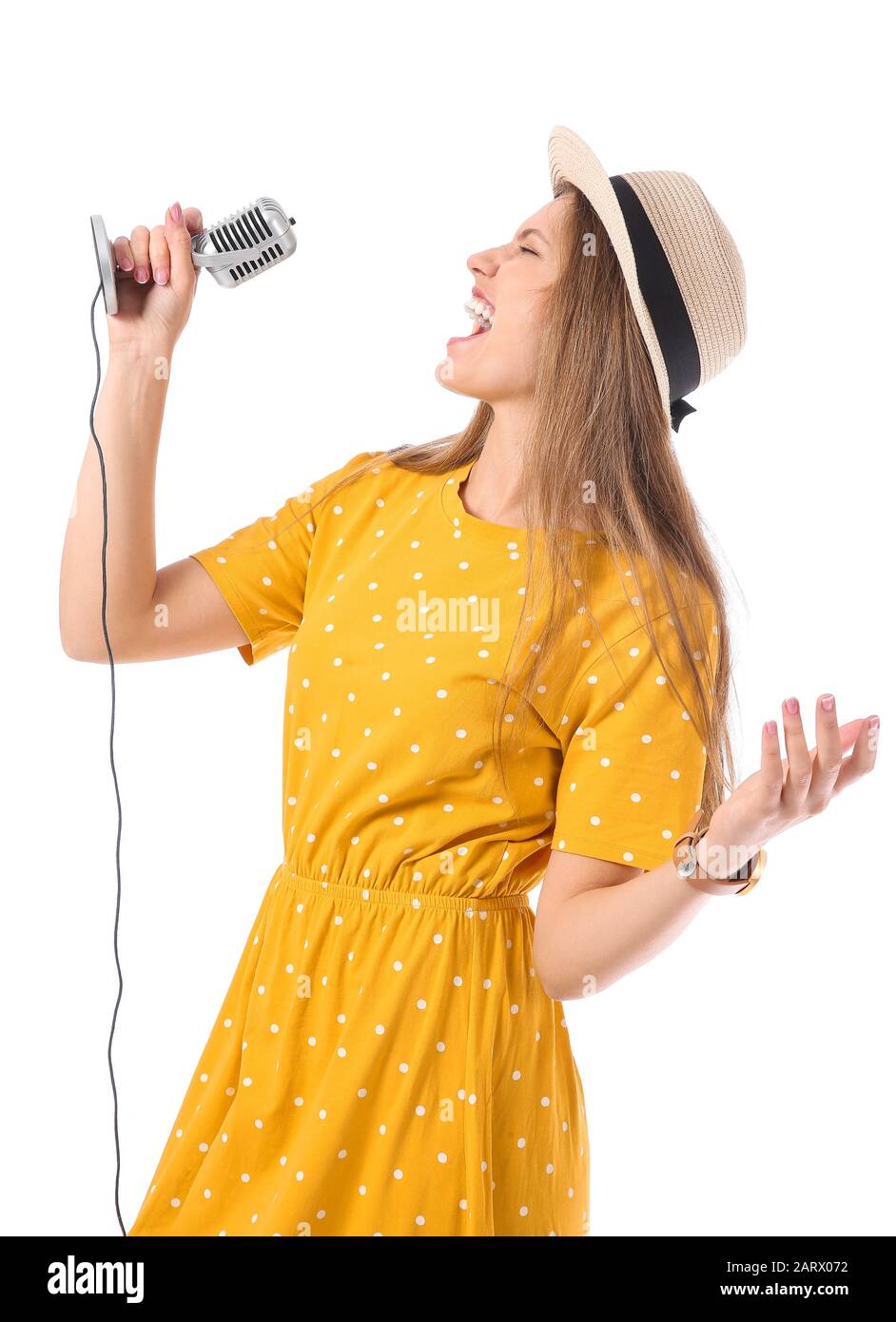 Beautiful young female singer with microphone on white background Stock