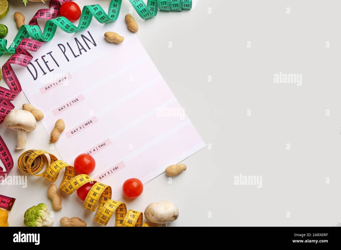 Sheet of paper with diet plan, measuring tapes and healthy products on ...