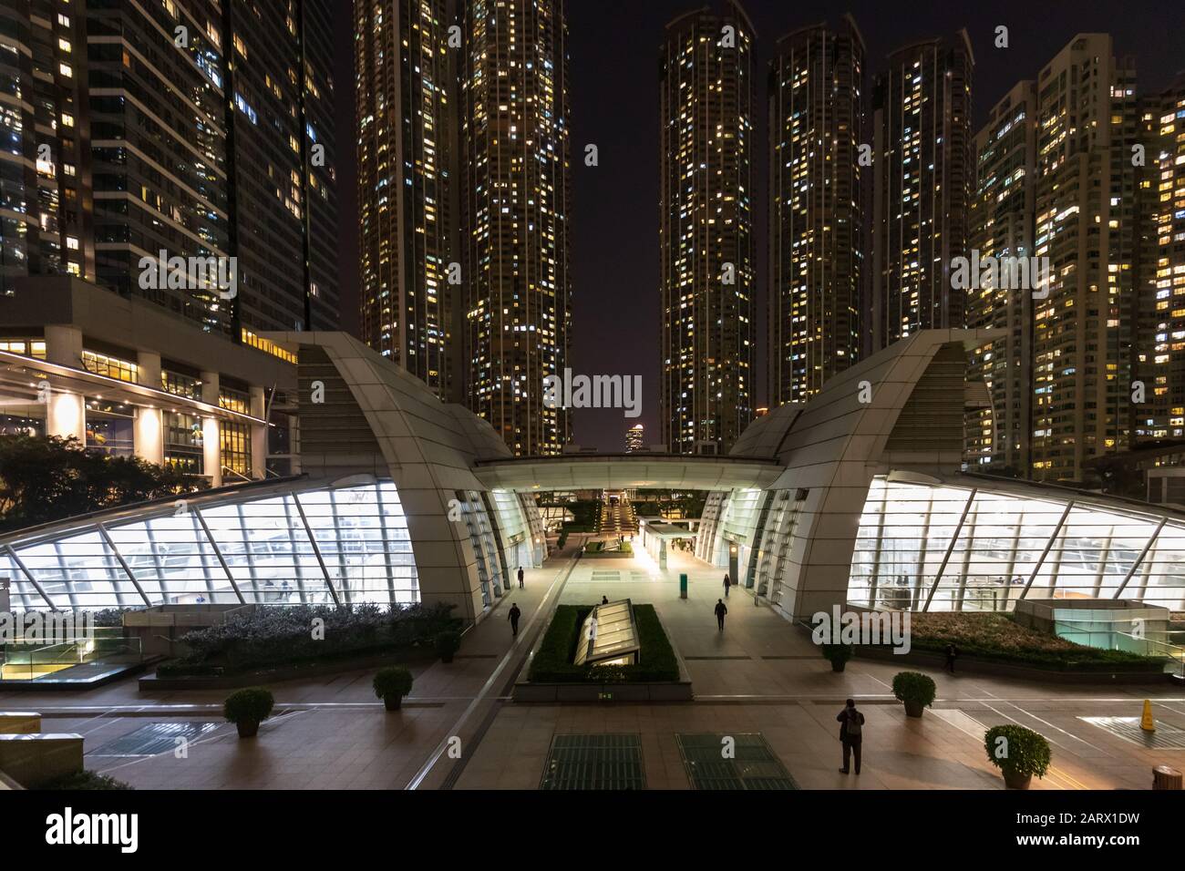 Public urban park surrounded by skyscrapers at night Stock Photo - Alamy