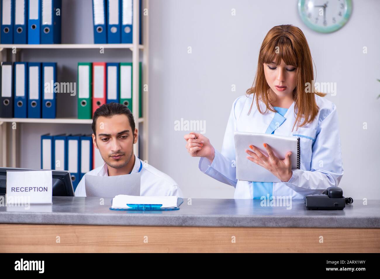 Two doctors working reception hi-res stock photography and images - Alamy