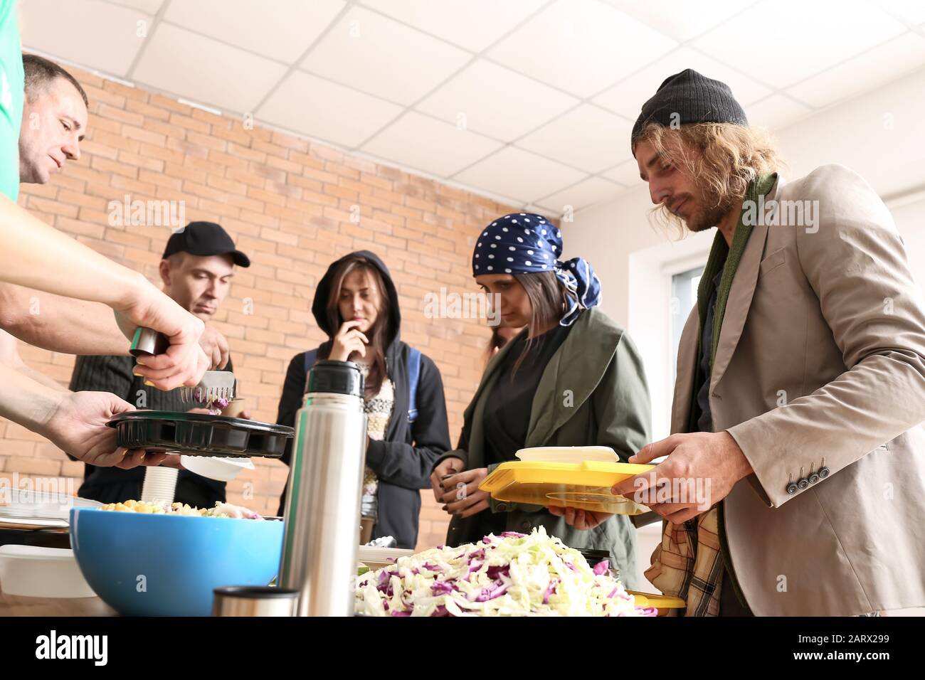 Volunteers giving food to homeless people Stock Photo Alamy