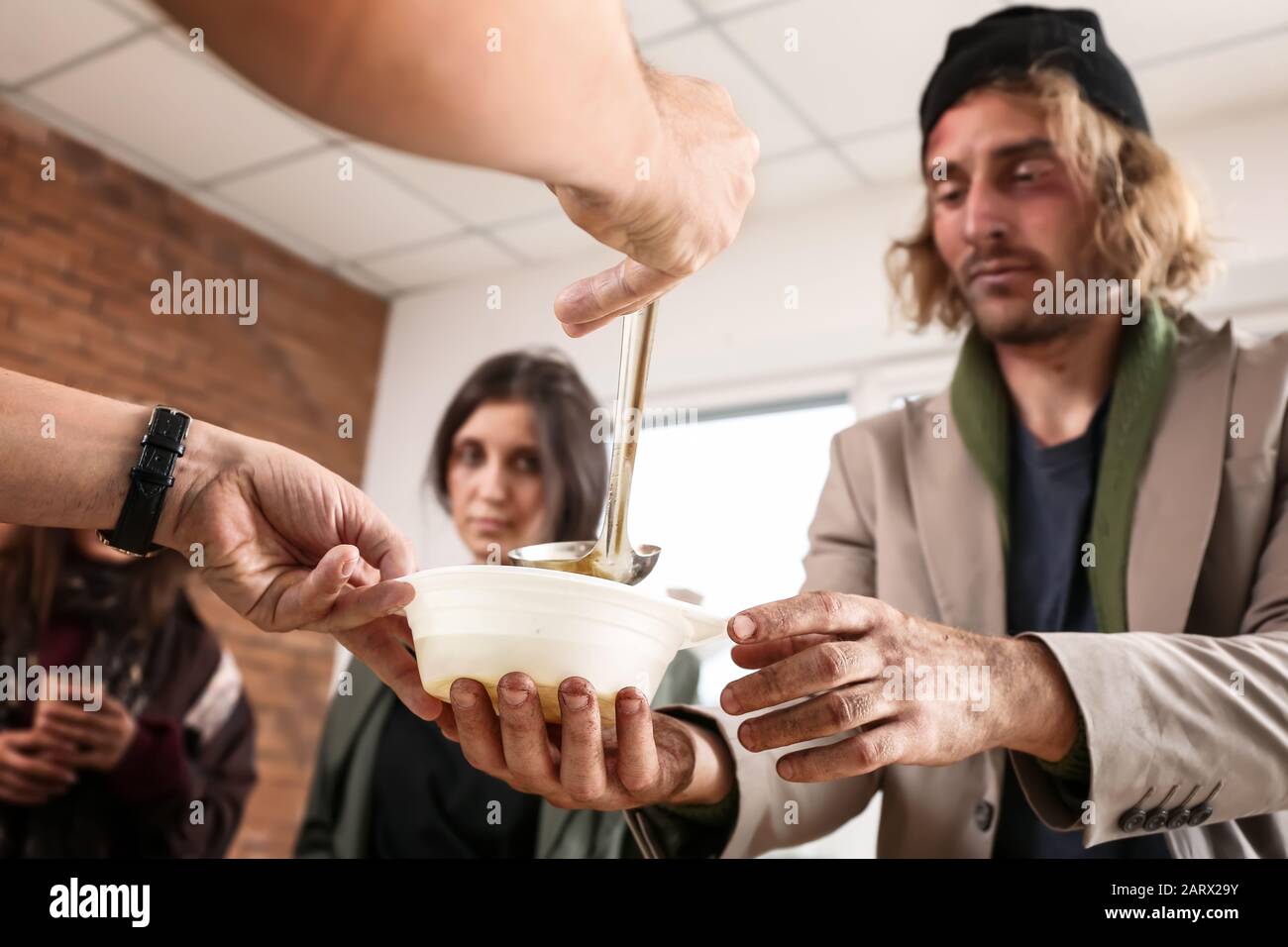 Volunteers giving food to homeless people Stock Photo Alamy