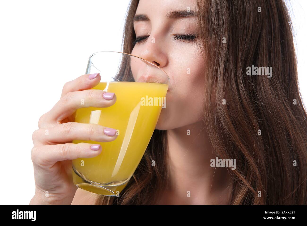 Beautiful young woman with orange juice on white background Stock Photo