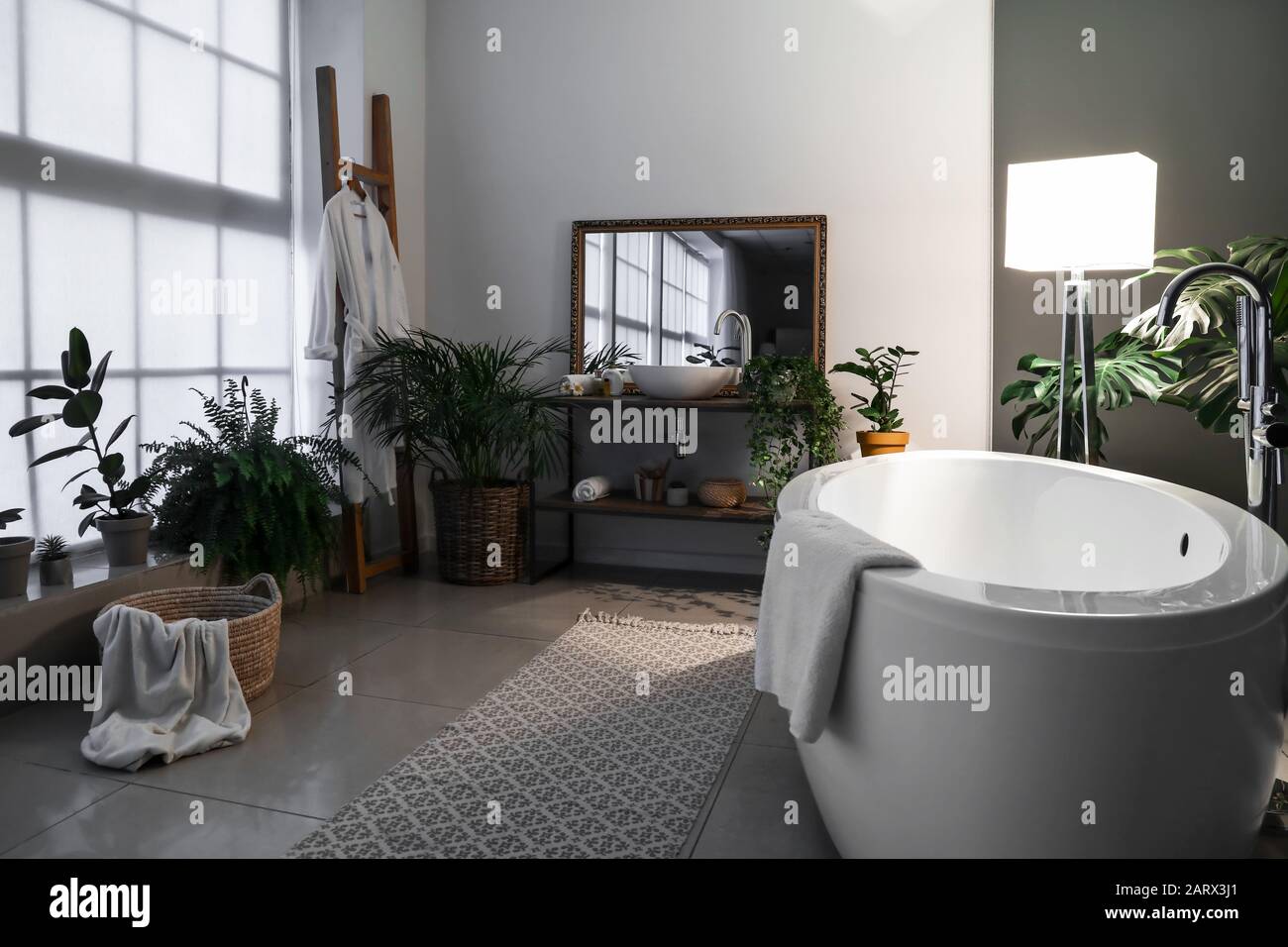 Stylish interior of bathroom at night Stock Photo Alamy