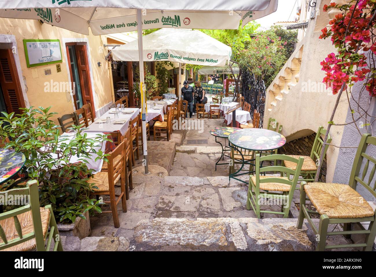 Athens - May 6, 2018: Street cafe with flowers and plants in Plaka district, Athens, Greece. Plaka is one of the main tourist attractions of Athens. Stock Photo