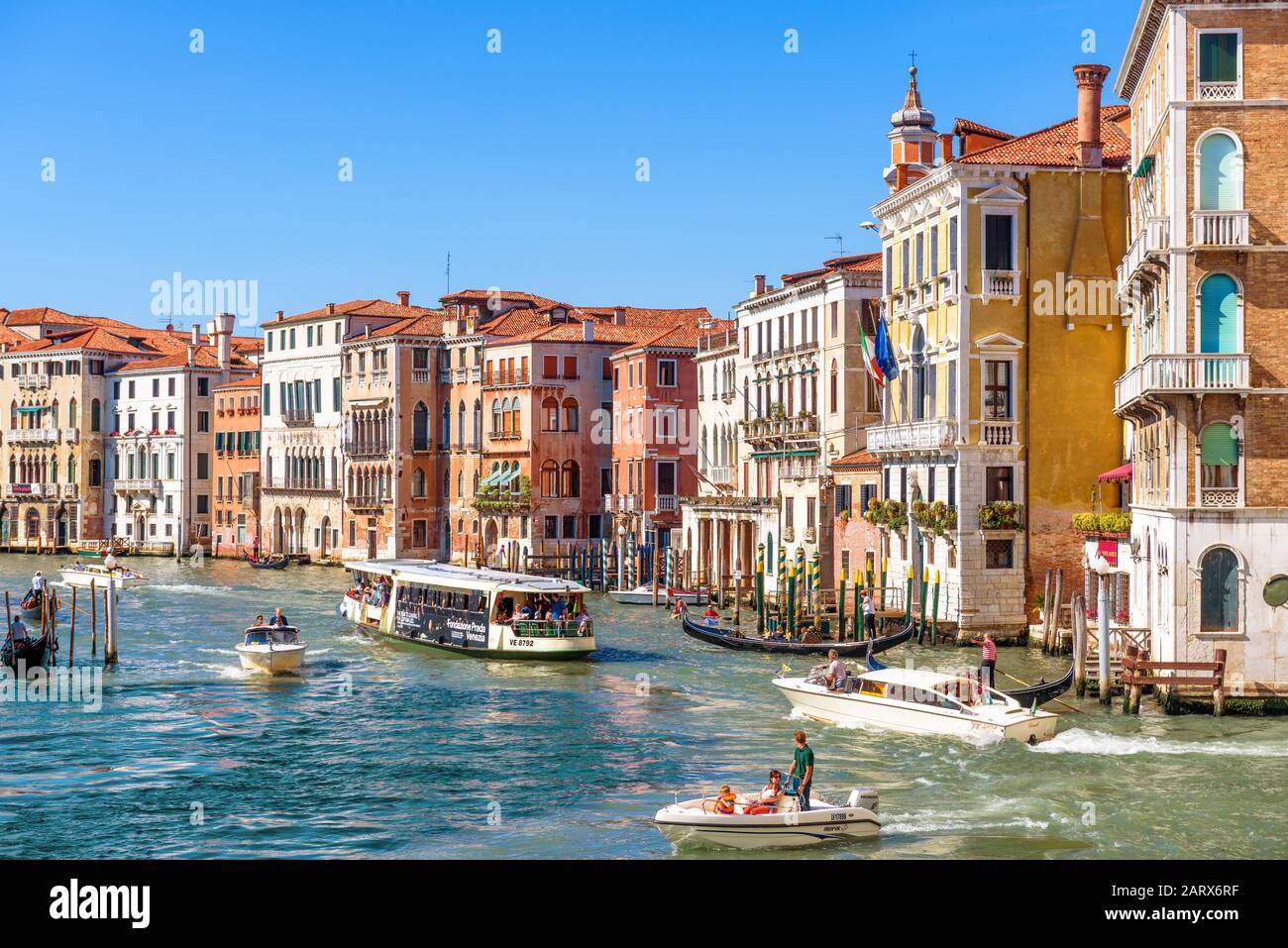 Venice, Italy - May 21, 2017: Sunny panorama of Grand Canal with tourist boats in Venice. Grand Canal is one of the main travel attractions of Venice. Stock Photo