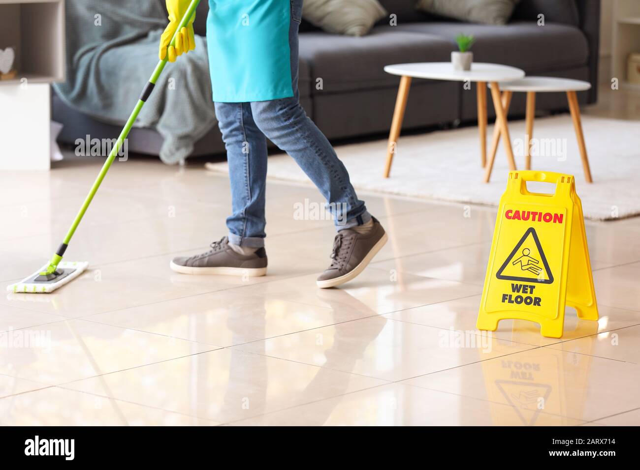 Male janitor mopping floor in flat Stock Photo Alamy