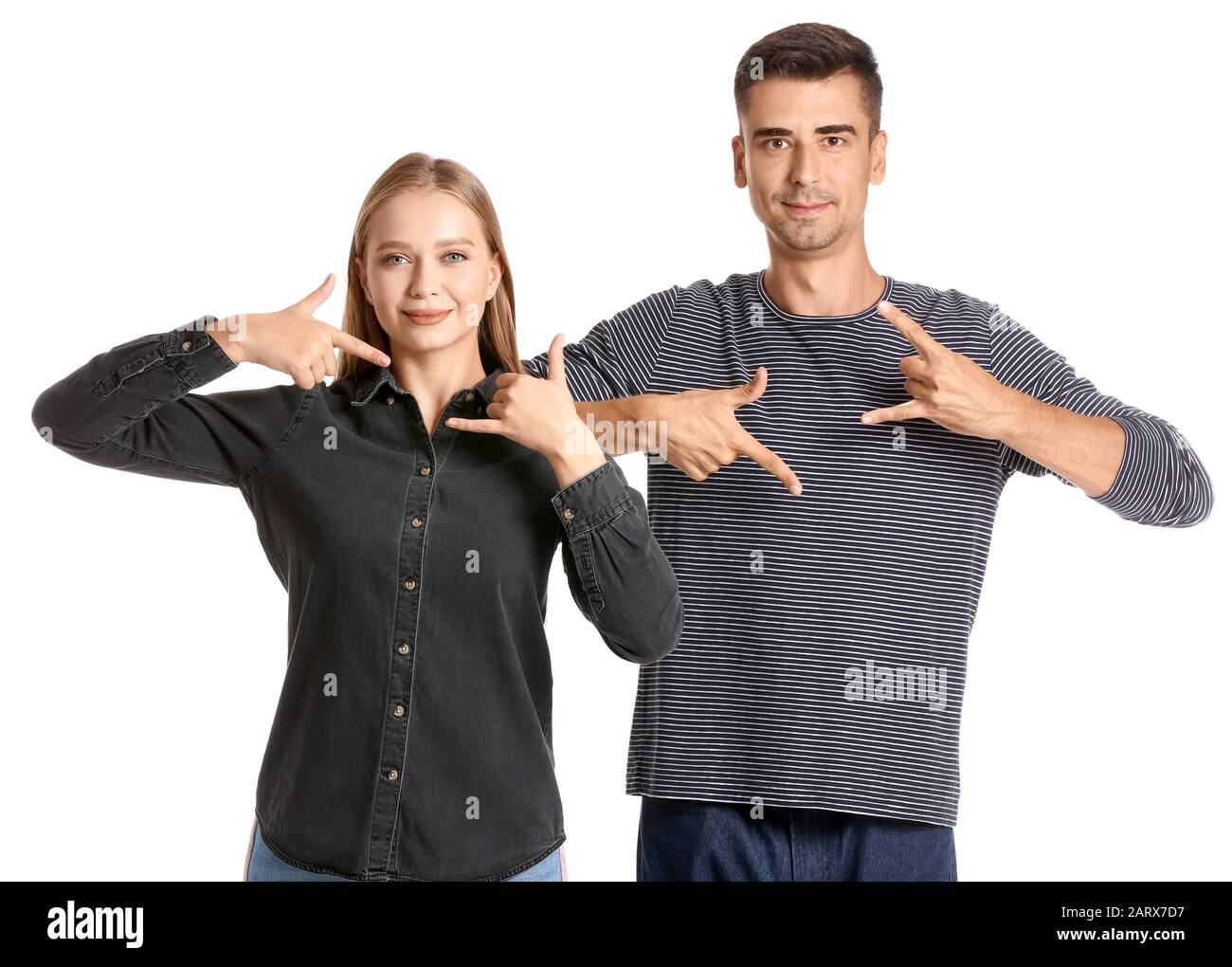 Young deaf mute couple using sign language on white background Stock