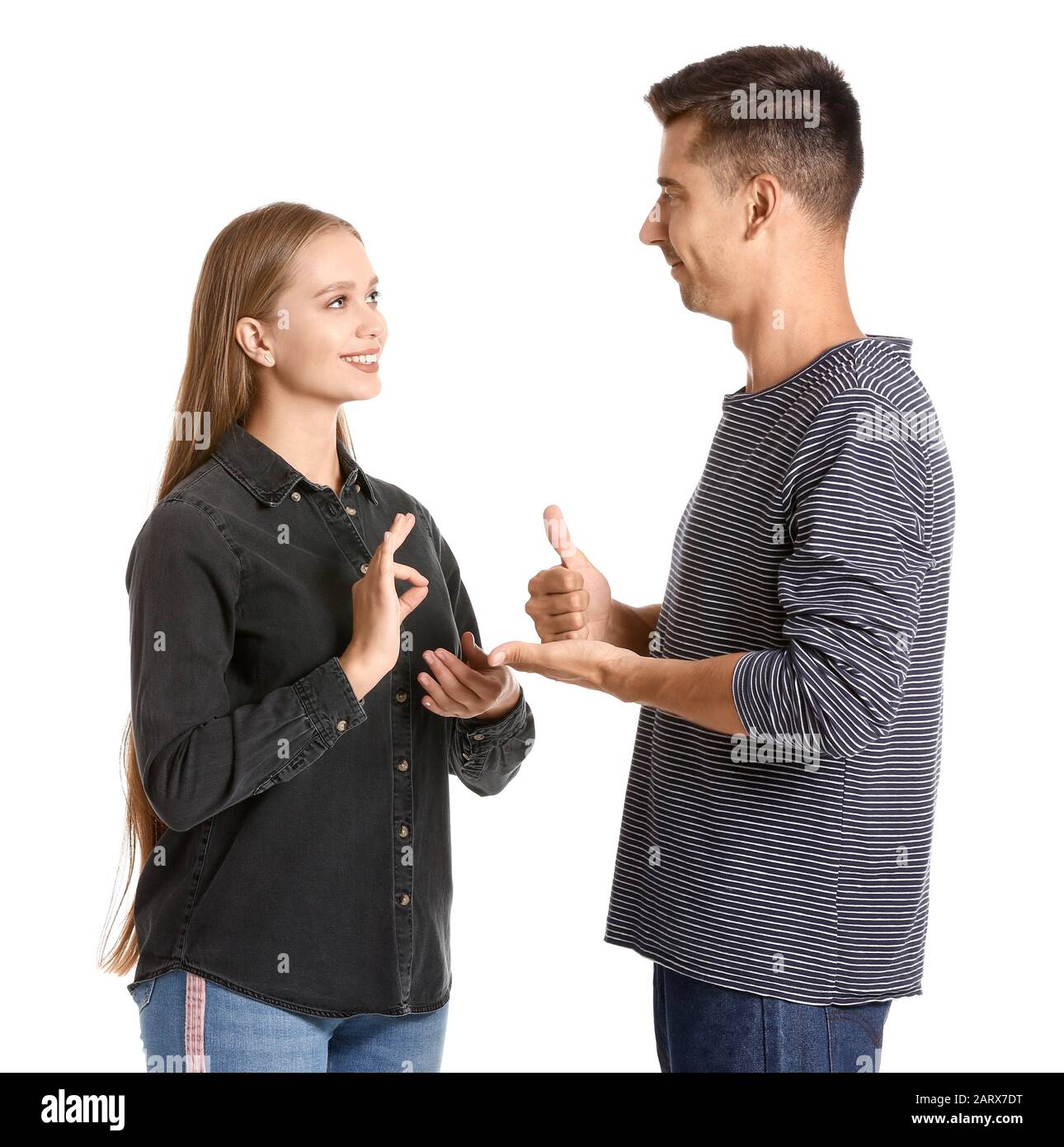 Young deaf mute couple using sign language on white background Stock
