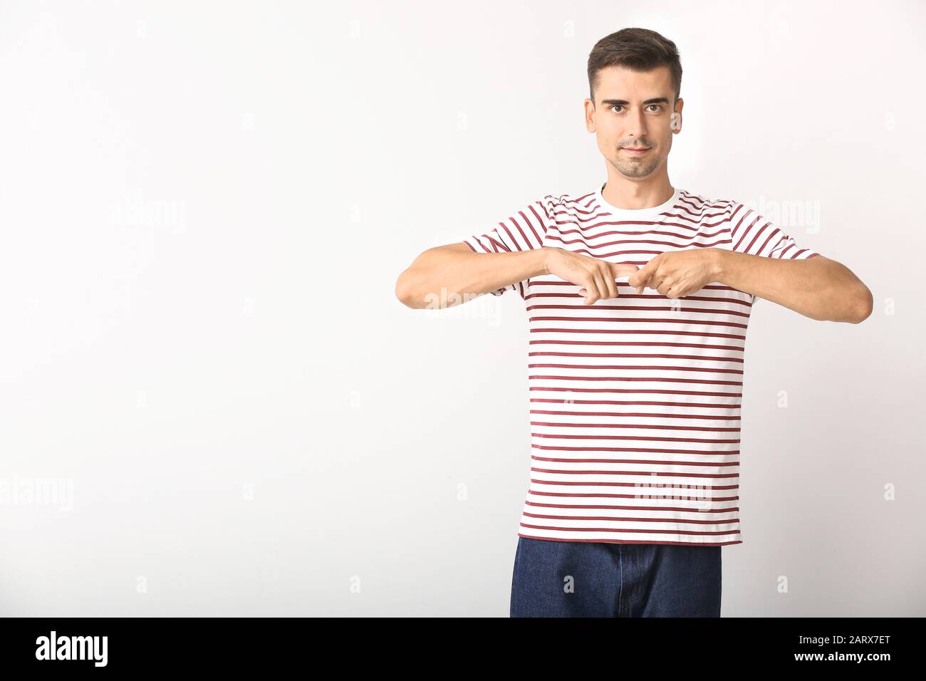 Young deaf mute man using sign language on white background Stock Photo ...