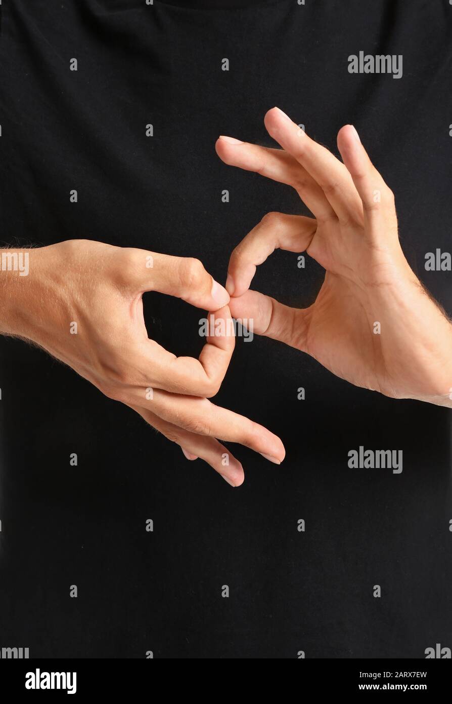 Young deaf mute man using sign language, closeup Stock Photo