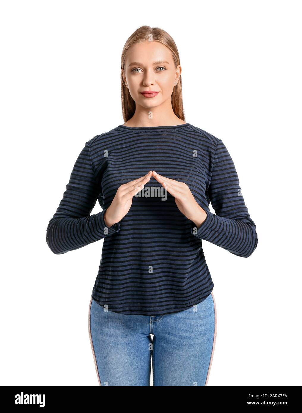 Young deaf mute woman using sign language on white background Stock Photo