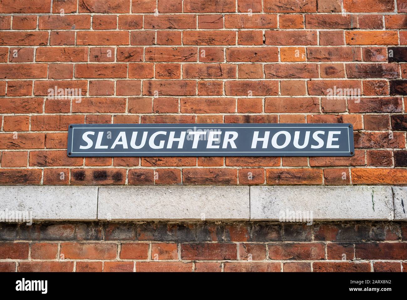 A Sign reading Slaughter house on a brick building Stock Photo
