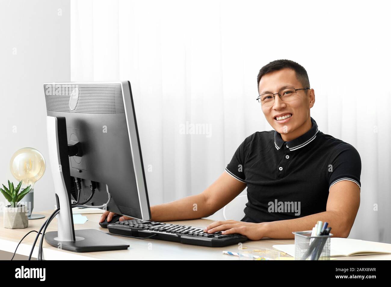 Asian programmer working on computer in office Stock Photo - Alamy