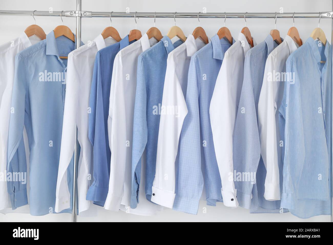 https://c8.alamy.com/comp/2ARXBA1/rack-with-clothes-in-modern-dry-cleaners-2ARXBA1.jpg