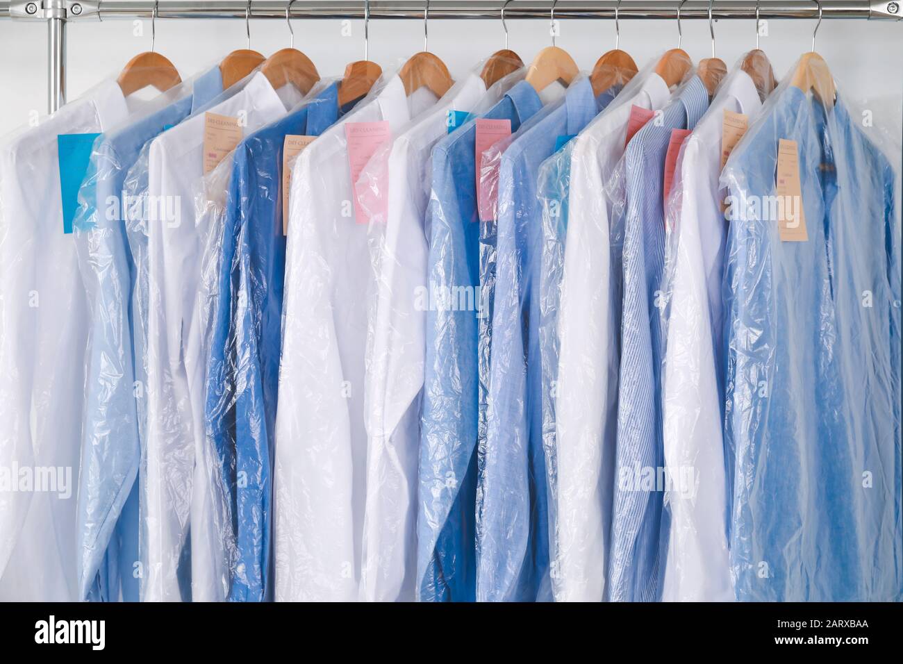 Rack with clothes in modern dry-cleaner's Stock Photo - Alamy