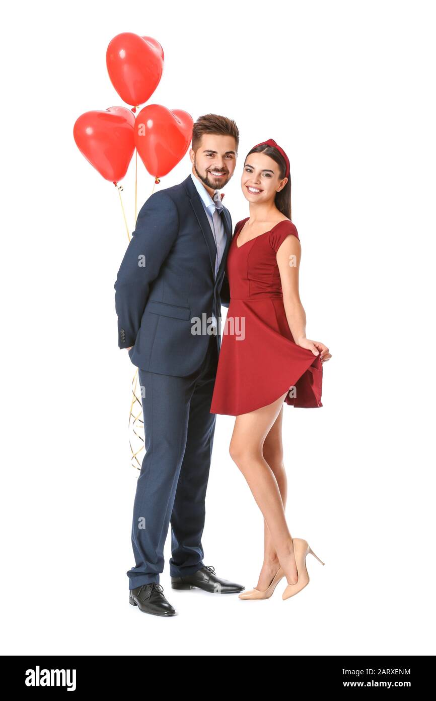 Portrait of beautiful young couple with air balloons on white ...