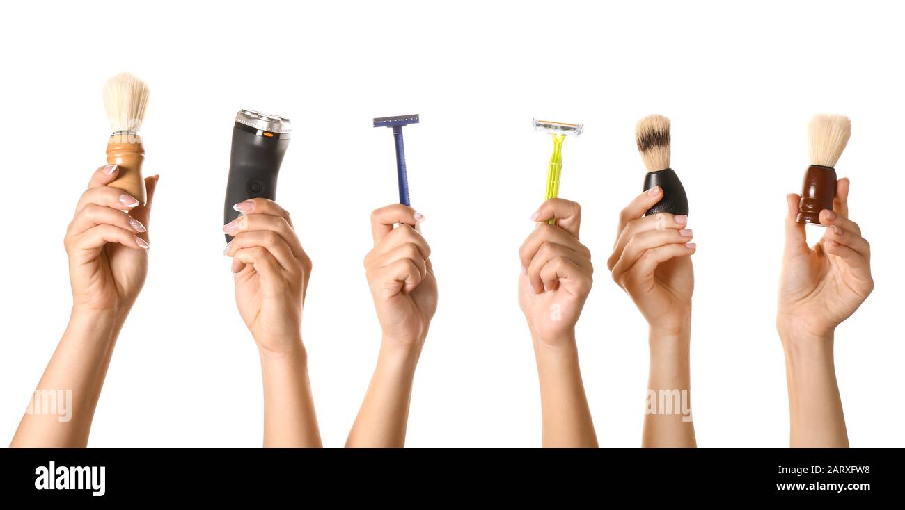 Hands with different tools for shaving on white background Stock Photo