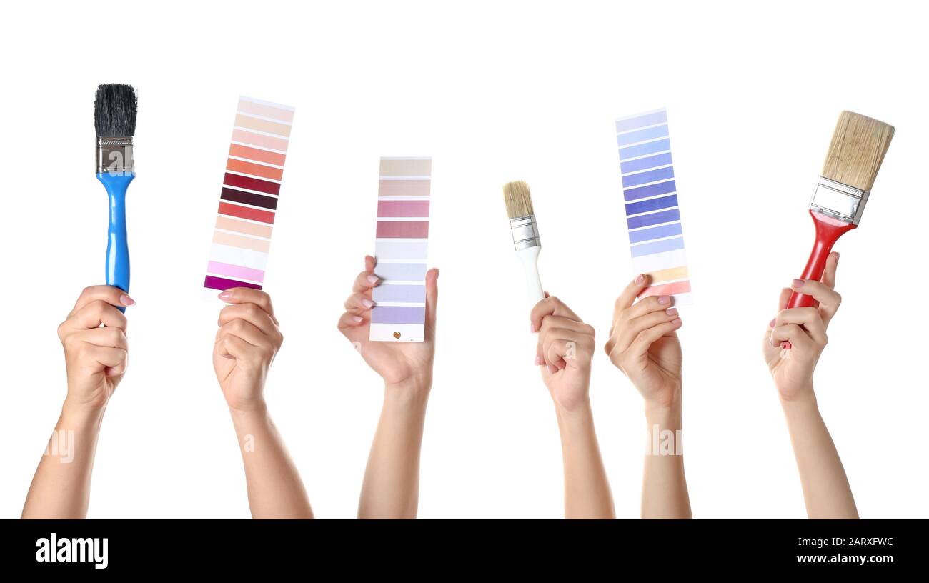 Female hands with paint brushes and color samples on white background ...