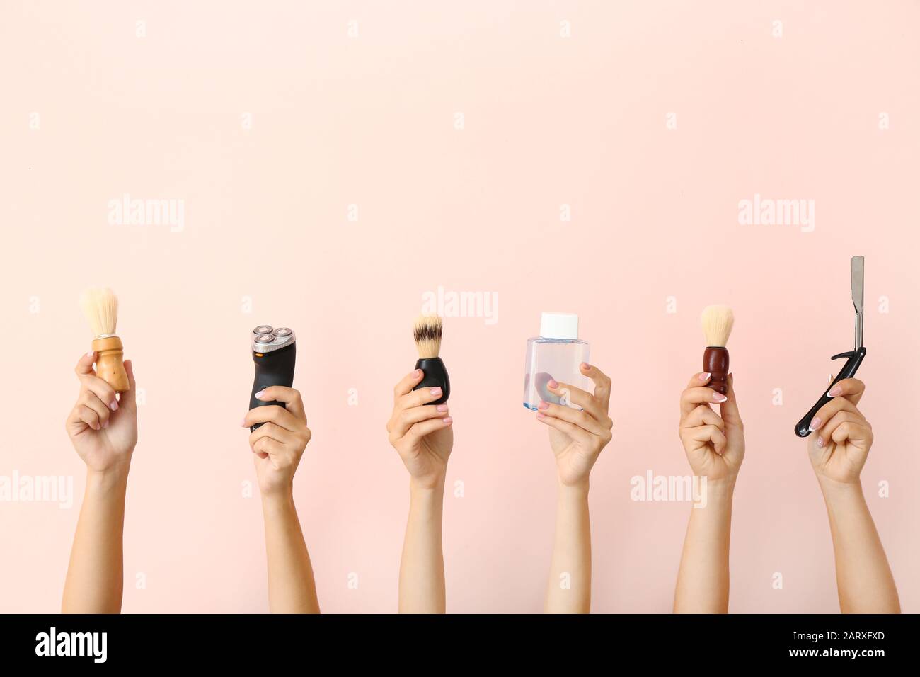Hands with different tools for shaving on color background Stock Photo